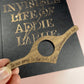 Never Pray To Gods Thumb Book Holder - Lost Minds Clothing